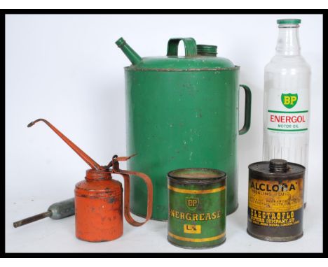 A group of vintage retro 20th century Industrial motoring oil advertising point of sale bottles and cans to include tall glas