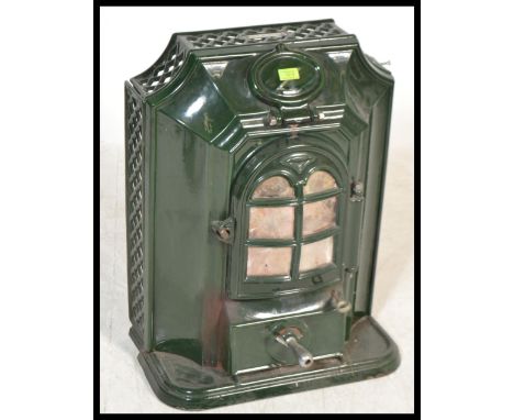 A French early 20th century green enamel stove in the manner of Godin having shaped facia and glass mica doors. Measures 66 c