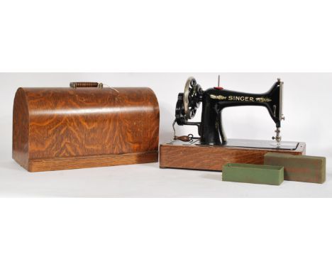 A cased Singer sewing machine, the case is faux crocodile skin