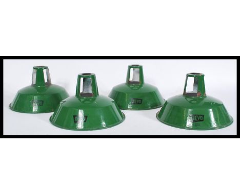 A set of four vintage retro 20th century industrial factory green enamel pendant shades by Revo with stenciled logos to sides