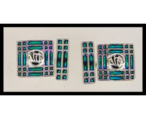 A pair of vintage Plique a Jour cuff links with geometric patterning and green panels, having chain link fastenings.