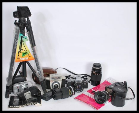 A selection of vintage 20th century film, video and digital cameras to include an Olympus skylight 49mm lens, a Hama tripod, 