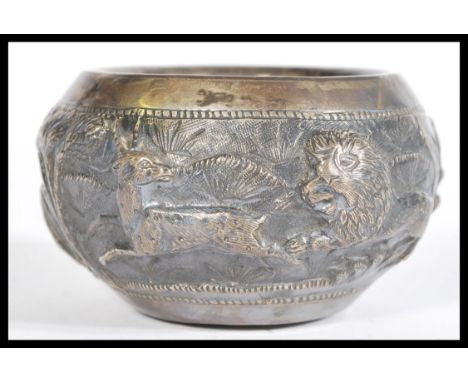 An early 20th century, possibly Lucknow, Indian bowl depicting embossed hunting scene with lions, deer and men with spears in