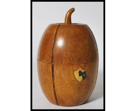 A 20th century Fruitwood Georgian style tea caddy in the form of a melon with a shield form scutcheon and key.