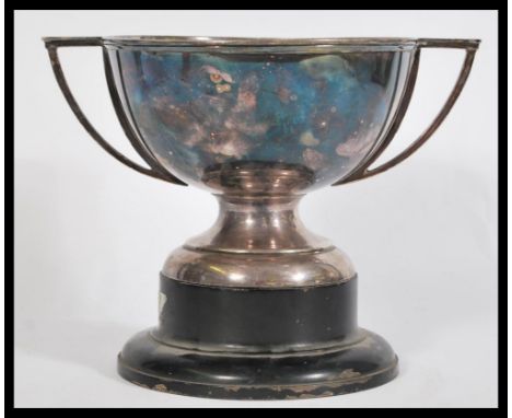 An early 20th Century twin handled silver plated Art Deco Trophy raised on an ebonised socle base.&nbsp;Measures: 20cm high x