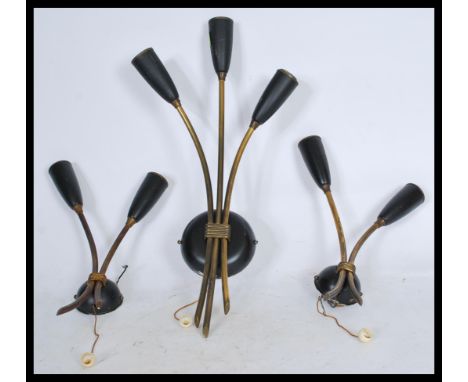 A group of three brass vintage retro 20th century wall lights with tulip sconces and chord pull switches. Includes one centra