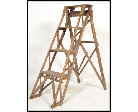 A vintage retro 20th century pine Industrial&nbsp; metamorphic step ladder. The folding ladder having original metal makers p