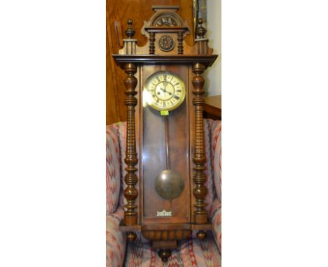 A Victorian walnut cased vienna regulator wall clock with good decorative large case having an enamel dial and brass pendulum
