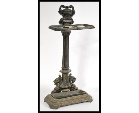 A 20th century cast iron stick stand in the manner of Coalbrookdale raised on a rectangular base with reeded leaf decoration.