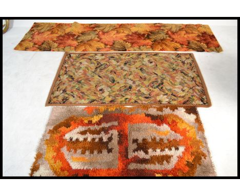 A group of three vintage 20th century retro floor carpet rugs one having maple leaf design along with a vibrant retro print e