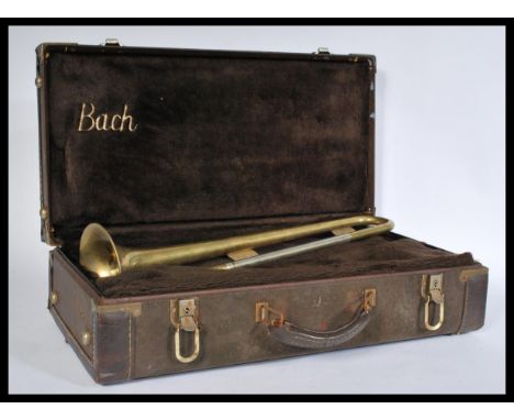A vintage 20th Century trumpet / bugle with&nbsp;incised ' B&amp;M Champion ' to the horn section, within a vintage leatheret