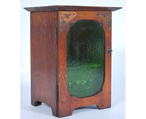 A vintage early 20th century Art Nouveau / Arts and Crafts oak smokers pipe cabinet having front green glass panel.&nbsp;Meas