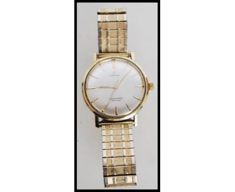 A 20th century Omega Seamaster Deville waterproof watch with a 10ct gold case, a metallic steel watch face with stick marking