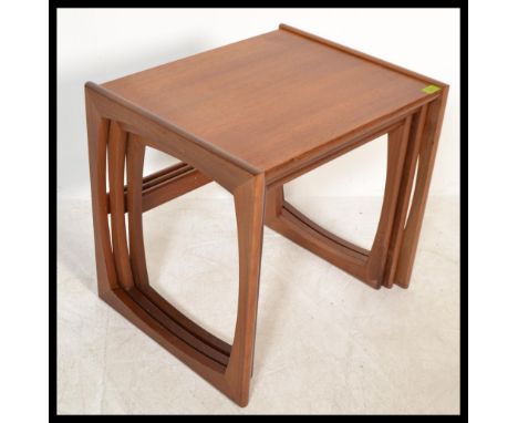 A 1970's G-Plan Kelso teak and tile top nest of tables. The tables of graduating form with tiled large table, plain smaller t