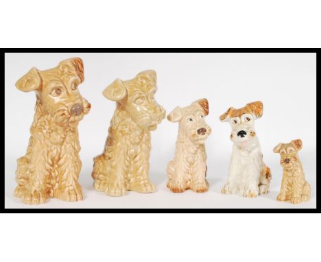 A collection of vintage 20th century graduating SylvaC ceramic figures of terriers including four of traditional matte glazin