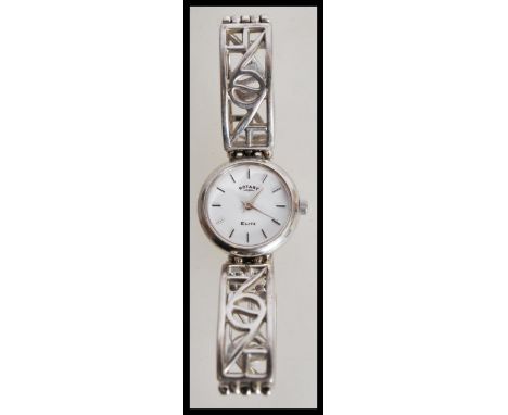 A ladies sterling silver rotary elite watch with a round white enamel chapter ring with stick markings and a banded bracelet 