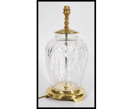 A&nbsp; Waterford crystal&nbsp; lead cut glass table lamp raised on a brass rounded pedestal having a knopped light top.&nbsp