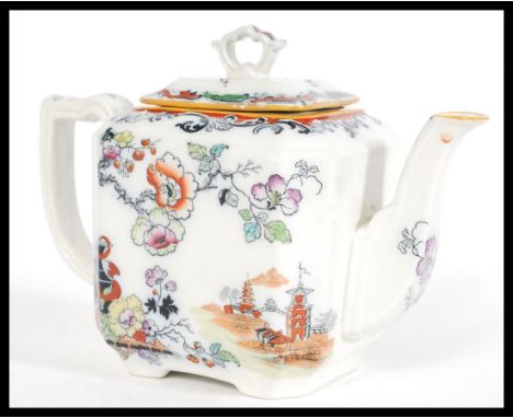 A 19th century Masons teapot having a chinoiserie pattern featuring Chinese pictorial scenes and peonies, with a fan form fin