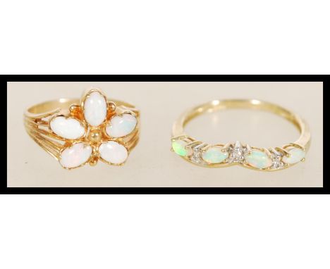 Two 9ct gold and opal rings to include a 9ct Sheffield hallmarked gold ring with five opals set into a floral head and a 9ct 