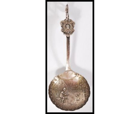 A rare early 20th century silver hallmarked London import silver caddy spoon with Dutch scenes and animal figure to handle. S