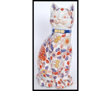 A large 20th Century Chinese ceramic enlightened lucky cat, decorated in a pattern of lotus and peony blossom, character mark
