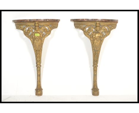 A pair of late 19th Century / early 20th Century gilt cast metal hall tables, each cast with the bust of Britannia and surmou