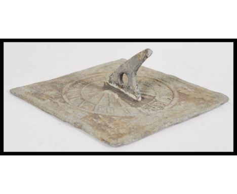 A 18th century Georgian lead sundial of square form which Latin inscriptions, and roman numerals to the chapter ring with som