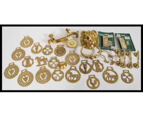 A group of vintage brass wares to include a gilt brass lion mask door knocker, door furniture and horse brasses. Please see i