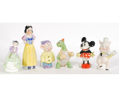 A group of ceramic vintage 20th century retro Disney toothbrush holder figurines to include Snow White, Minnie Mouse, Toby To