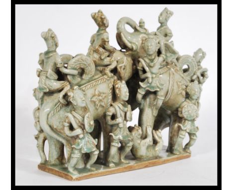 A 20th century Asian Cambodian ceramic figure group with a mint crackle glaze on a rectangular base depicting two Asian eleph