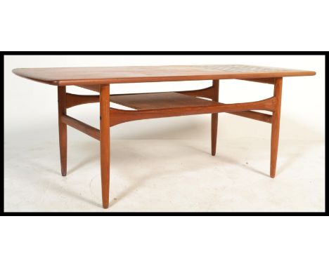 A vintage retro 1960's/70's teak rectangular coffee table with rounded edges, having a blue tiled hot plate section to the st