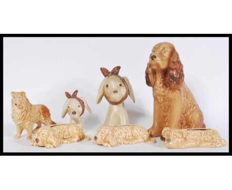 A mixed collection of vintage 20th century SylvaC ceramic figurines to include three brown dog form planters, a pair of 'toot