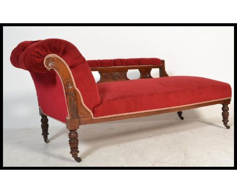 An early 20th Century Edwardian chaise lounge with upholstered button back seat, scrolled back and arm rest, carved detail an