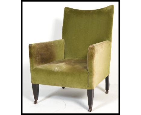 A late 19th century Victorian / Edwardian mahogany armchair having a shaped back and being raised on&nbsp; square tapering le