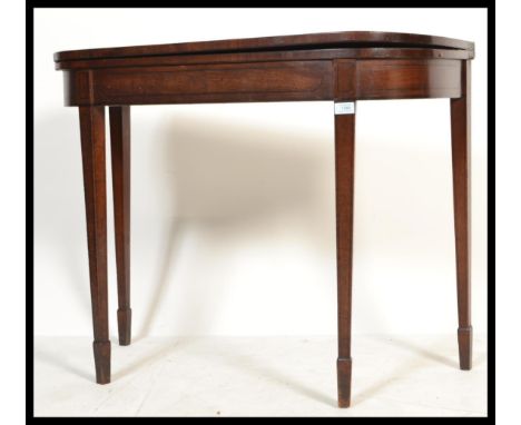 An 18th / 19th century George III mahogany and line ebony inlaid tea table / games card table. Raised on square tapering legs