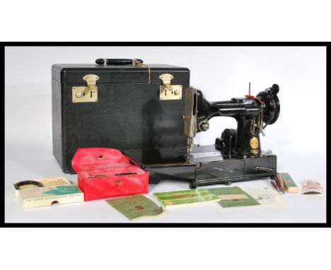 A vintage 20th century Singer Featherweight convertible portable sewing machine model number 222k complete in original case f