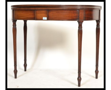 An 18th / 19th century George III mahogany&nbsp; tea table / games card table. Raised on reeded tapering legs, above a fitted
