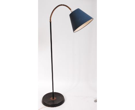 A 1950s French black enamelled standard lamp, having brass cased adjustable action, raised on circular base, max. h.150cm    