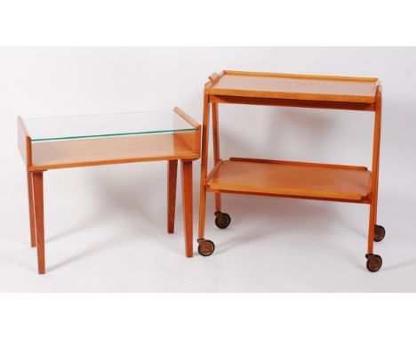 A 1950s light oak two tier tea trolley, having upper removable tray and raised on roller castors, h.76cm, w.74cm, d.41cm; tog