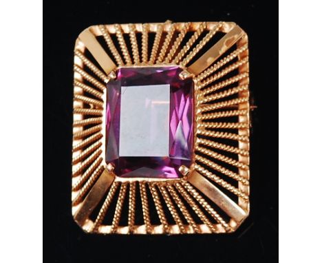 A modern 18ct gold and amethyst set pendant, the emerald cut amethyst measuring approx 2.1 x 1.6 x 0.8cm, in a tiered and pie