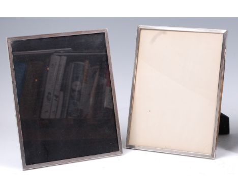 A pair of mid-20th century silver mounted easel photograph frames, each having engine turned front edge, mounted on ebonised 