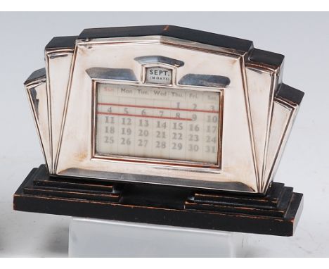 An Art Deco ebonised and silver mounted desk calendar, of architectural outline, maker W J Myott & Co, Birmingham 1934, w.17c