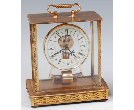 A gilt brass cased and four glass Kundo electronic mantel clock, having a swing handle and white enamel chapter ring with Rom