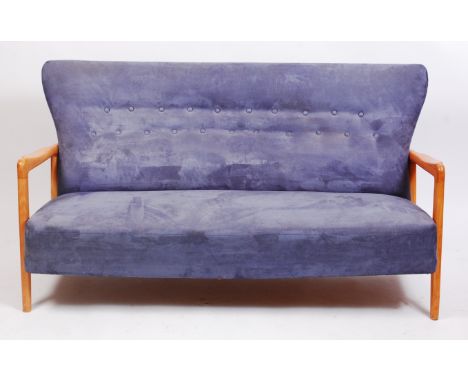 A 1950s Danish blond beech framed and blue suede buttonback upholstered three seater sofa, having open arms, w.165cm