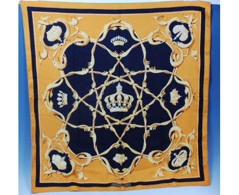 A 1960s Hermès of Paris silk scarf, decorated in black and gold with crown motifs, artist Julia Abadie, within scroll floral 