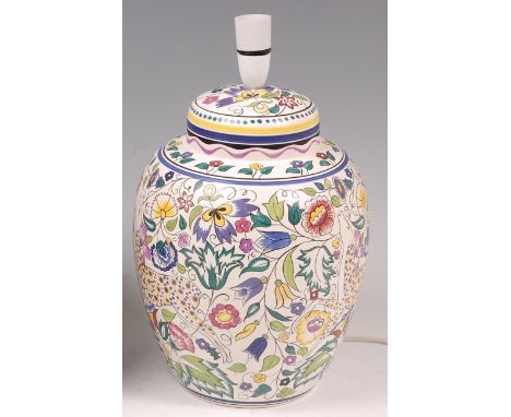 A Poole Pottery table lamp by Susan Russell, of bulbous tapering form, with typical bright coloured floral stylised decoratio