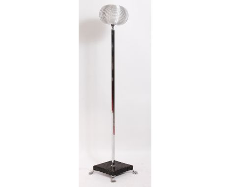 An Art Deco chrome standard lamp, having replacement wirework shade over hexagonal column to lozenge shaped ebonised wood bas