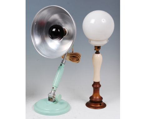 An Art Deco Junolux bakelite and anodised metal desk lamp, having tilting action and one domed base with raised mark, h.52cm;