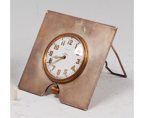 An Art Deco engine turned silver framed easel bedside clock, by Finnigans Ltd of London, having eight day winding movement, L