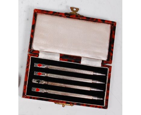 A cased set of four Art Deco sterling silver propelling pencils, each having engine turned stems, the terminals enamel decora